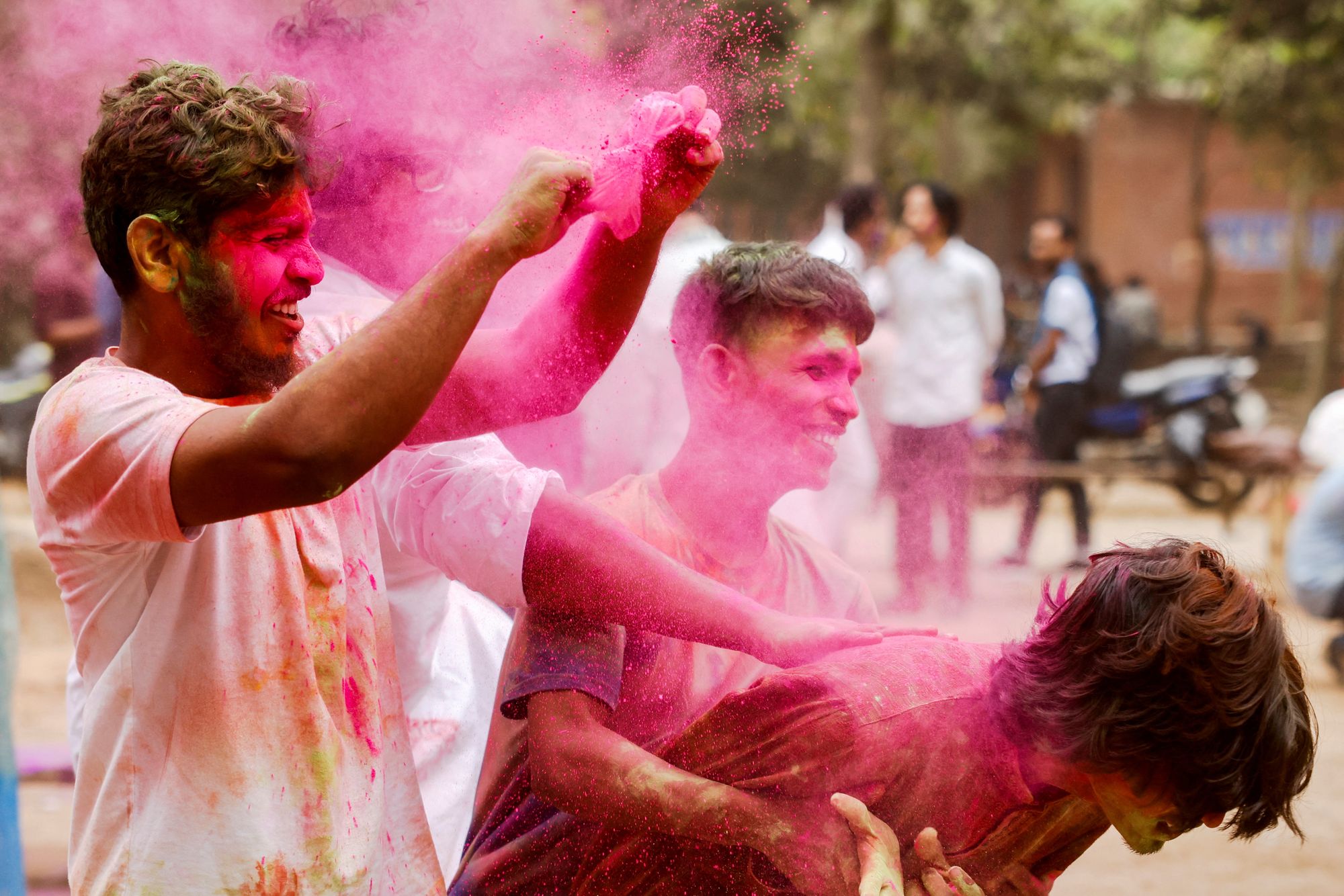 People celebrate Holi with colorful powders