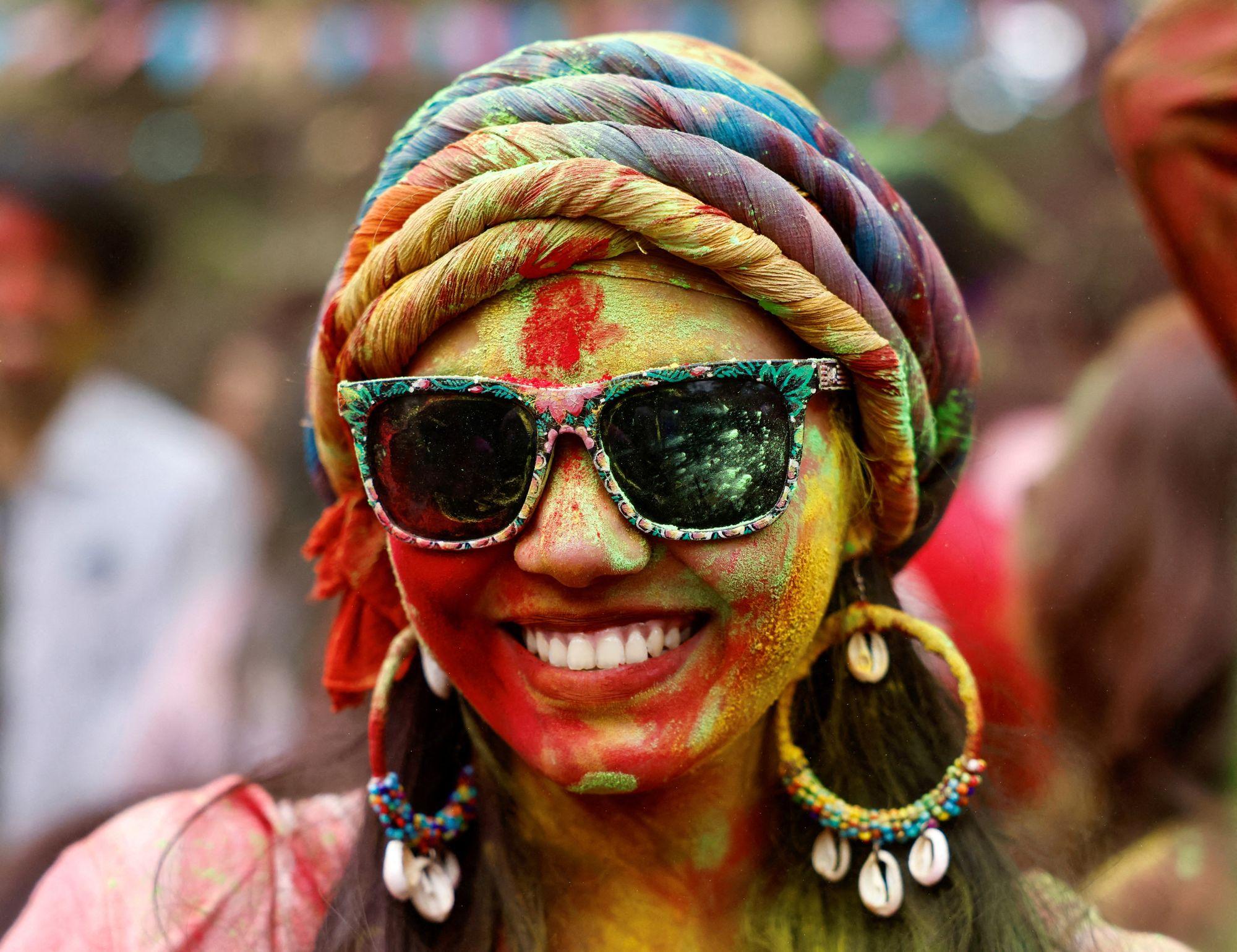 A girl smiles during the celebration of Holi