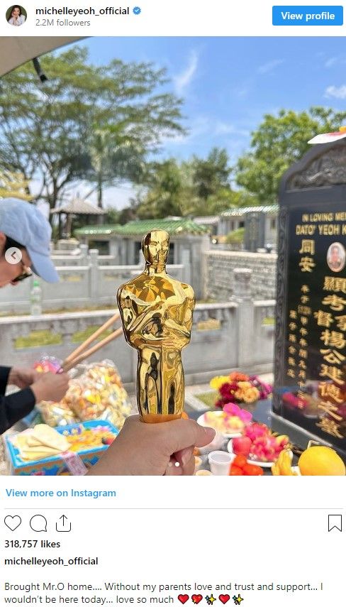Michelle Yeoh visits her father's grave with her Oscar award