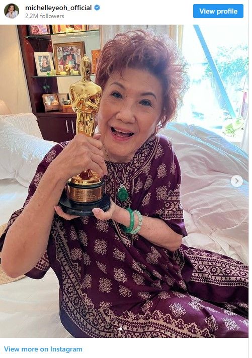 Michelle Yeoh's mom poses with Yeoh's Oscar award