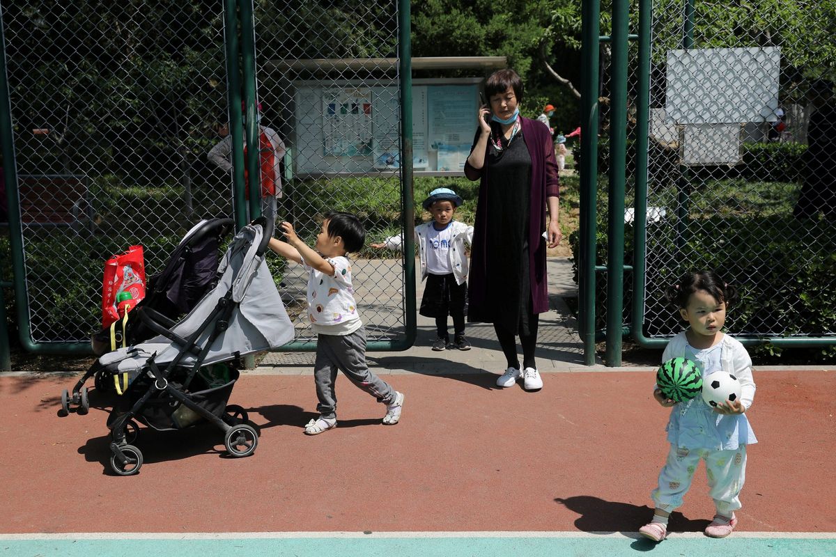 Why was China’s three-child policy announcement met with such mixed responses?