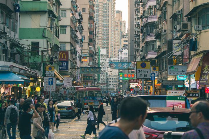 People On Road Between Buildings in Hong Kong 