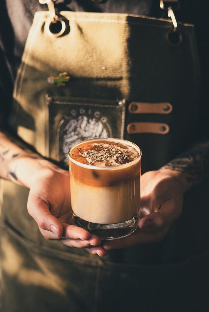 photo of barista holding iced coffee