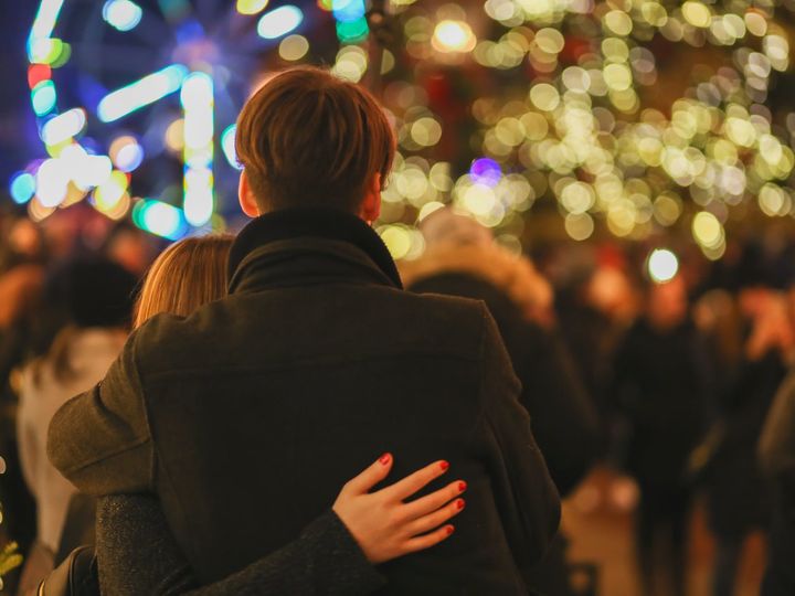 unrecognizable couple enjoying christmas holidays on street