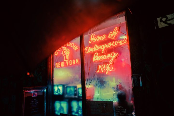 window of shop with glowing neon signboards