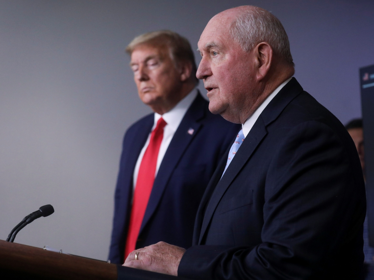 US President Donald Trump listens as US Secretary of Agriculture Sonny Perdue addresses the daily coronavirus task force briefing at the White House.