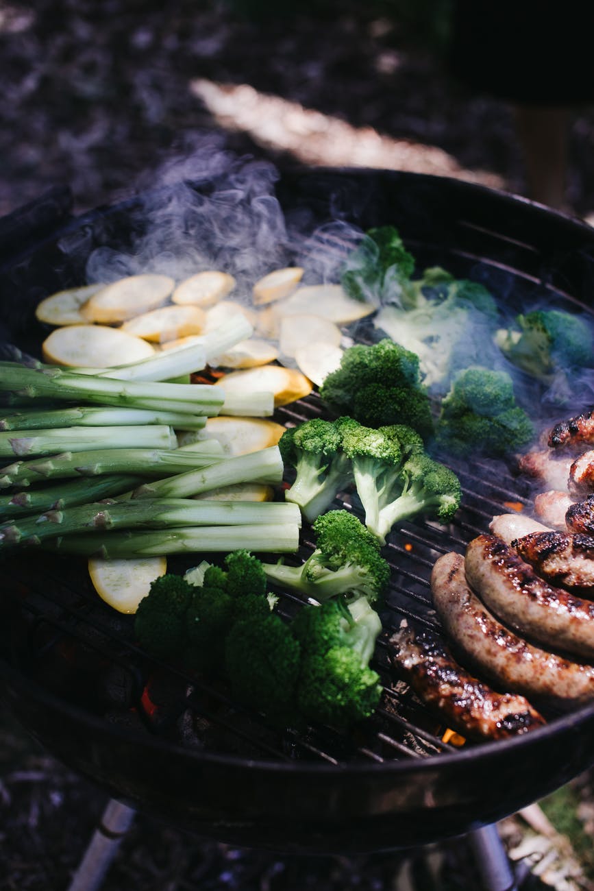 vegetables and sausages on grill in daytime
