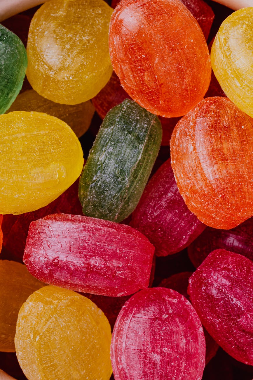 various delicious colorful caramel sweets as background